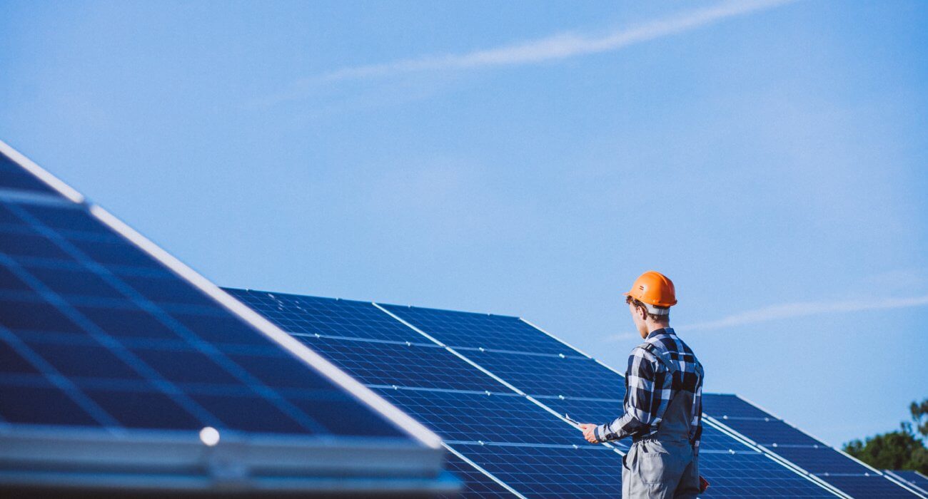 man-worker-firld-by-solar-panels